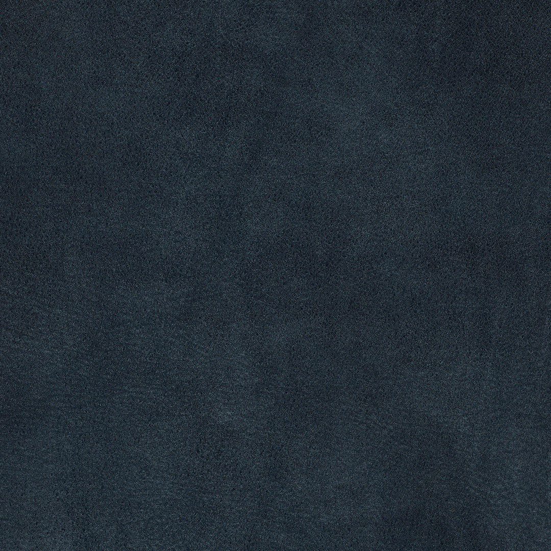 Close-up texture of royal blue suede fabric showing soft, velvety surface detail