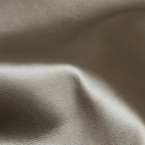 Close-up of smooth brown Asher Leather material with natural texture and soft sheen