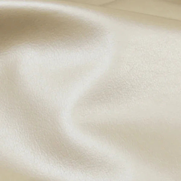 Close-up of smooth, cream-colored Asher Leather texture with natural grain.